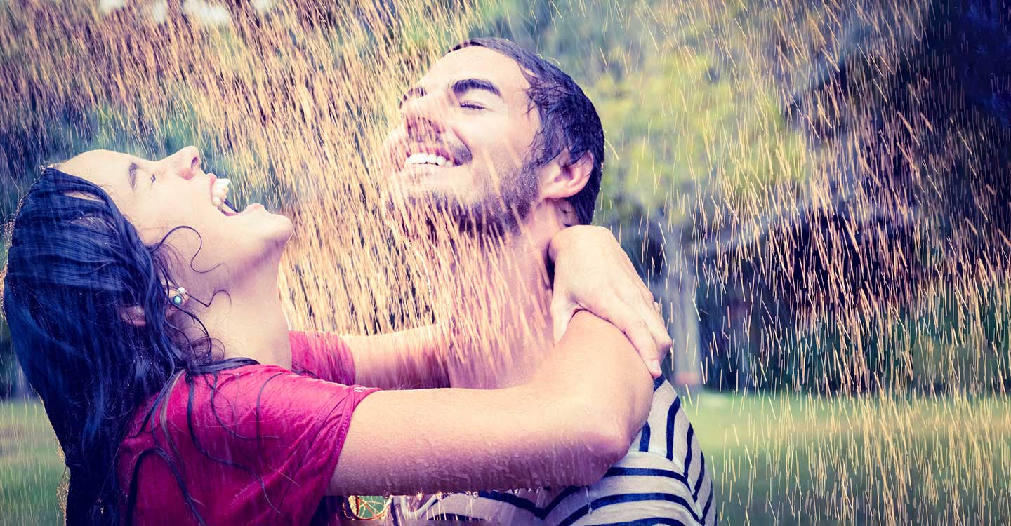 young couple hugging in rain