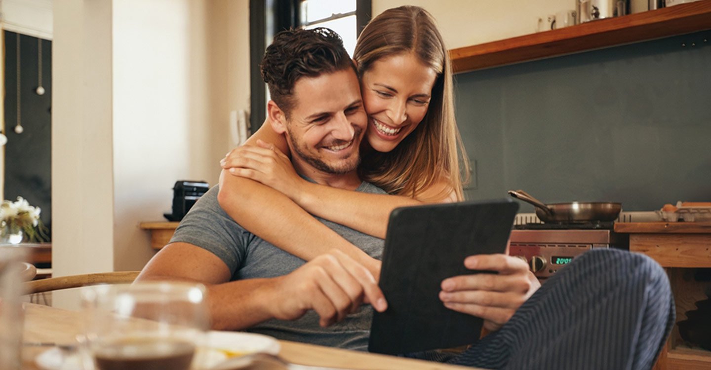 Loving Young Couple On Tablet
